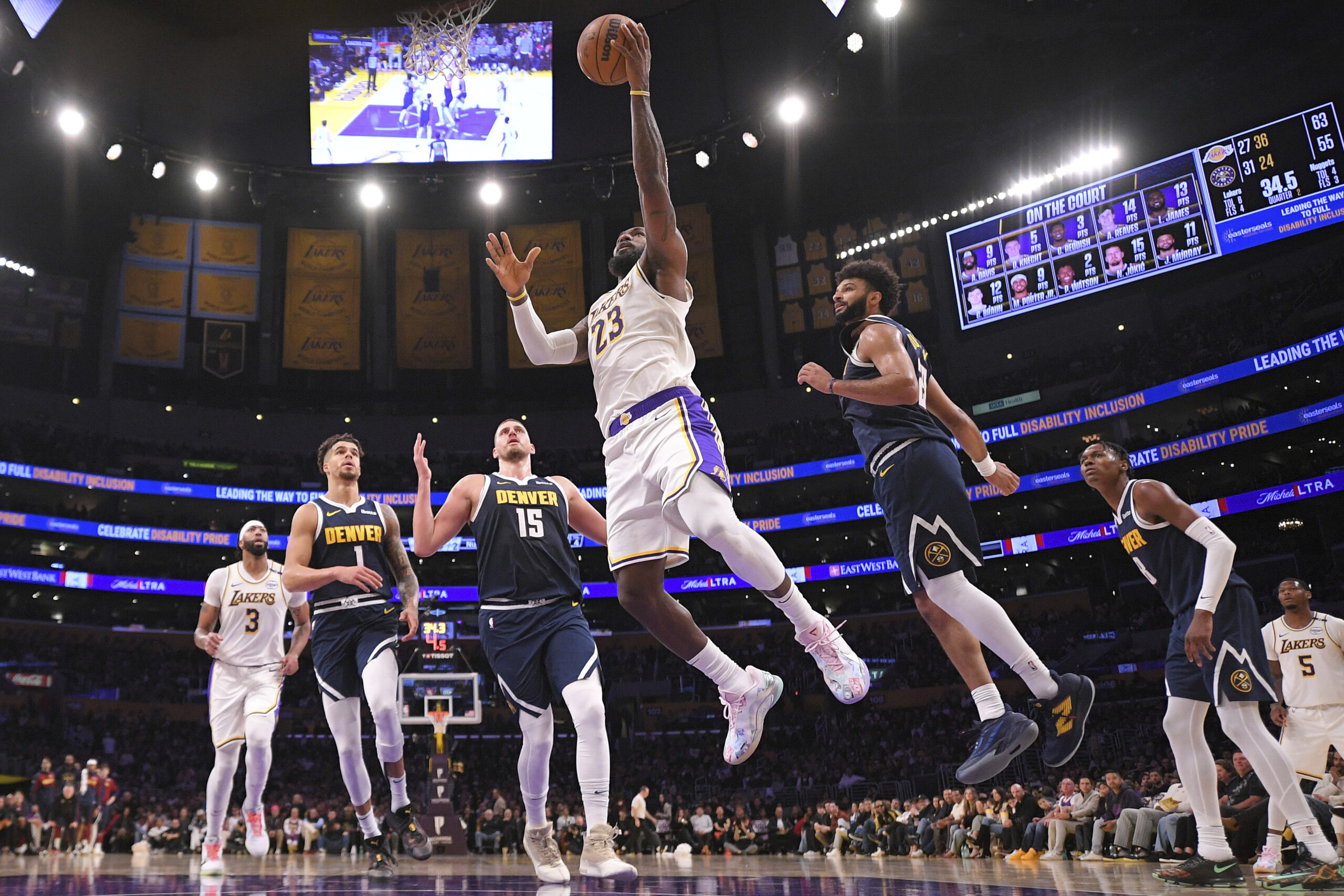 Los Angeles Lakers forward LeBron James (23) shoots as Denver Nuggets forward Michael Porter Jr. (1), center Nikola Jokic (15), guard Jamal Murray (27) and forward Michael Porter Jr. (1) defend during the first half of an NBA basketball game, Saturday, Nov. 23, 2024, in Los Angeles. (AP Photo/Mark J. Terrill)