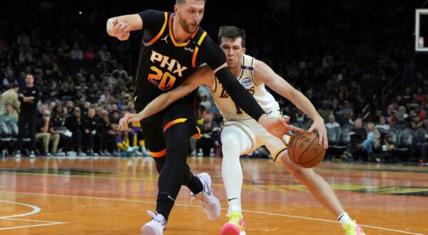 Phoenix Suns center Jusuf Nurkic (20) steals the ball from Los Angeles Lakers guard Austin Reaves during the second half of an NBA basketball game, Tuesday, Nov. 26, 2024, in Phoenix. (AP Photo/Rick Scuteri) Lakers Suns Basketball