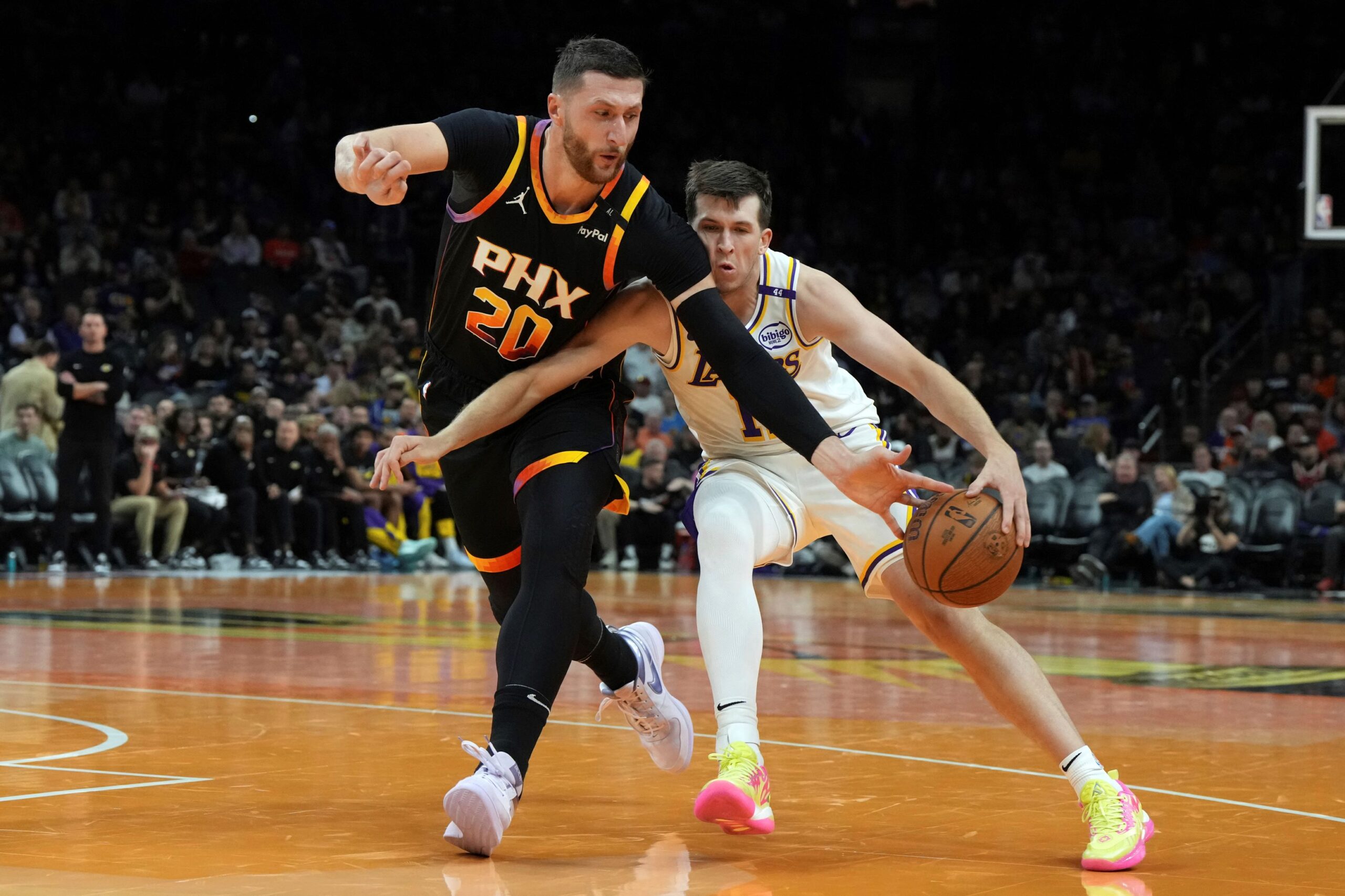 Phoenix Suns center Jusuf Nurkic (20) steals the ball from Los Angeles Lakers guard Austin Reaves during the second half of an NBA basketball game, Tuesday, Nov. 26, 2024, in Phoenix. (AP Photo/Rick Scuteri) Lakers Suns Basketball