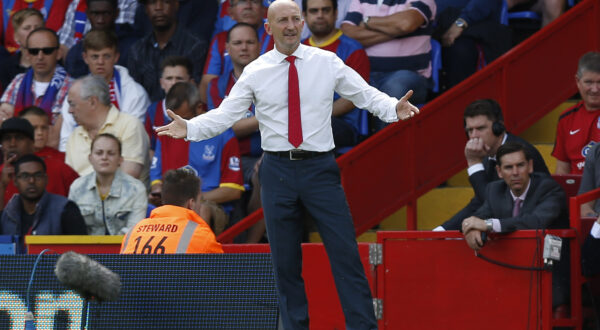 FILE - A Sunday, Aug. 18, 2013 photo from files showing Crystal Palace's manager, Ian Holloway, on the touchline as he watches his team play against Tottenham Hotspur during their English Premier League soccer match at Selhurst Park, London. Ian Holloway has left his position as Crystal Palace manager by mutual consent, with the club next to last in the Premier League after eight games. Holloways departure was confirmed at a press conference in central London on Wednesday, Oct. 23, 2013. (AP Photo/Sang Tan, File)