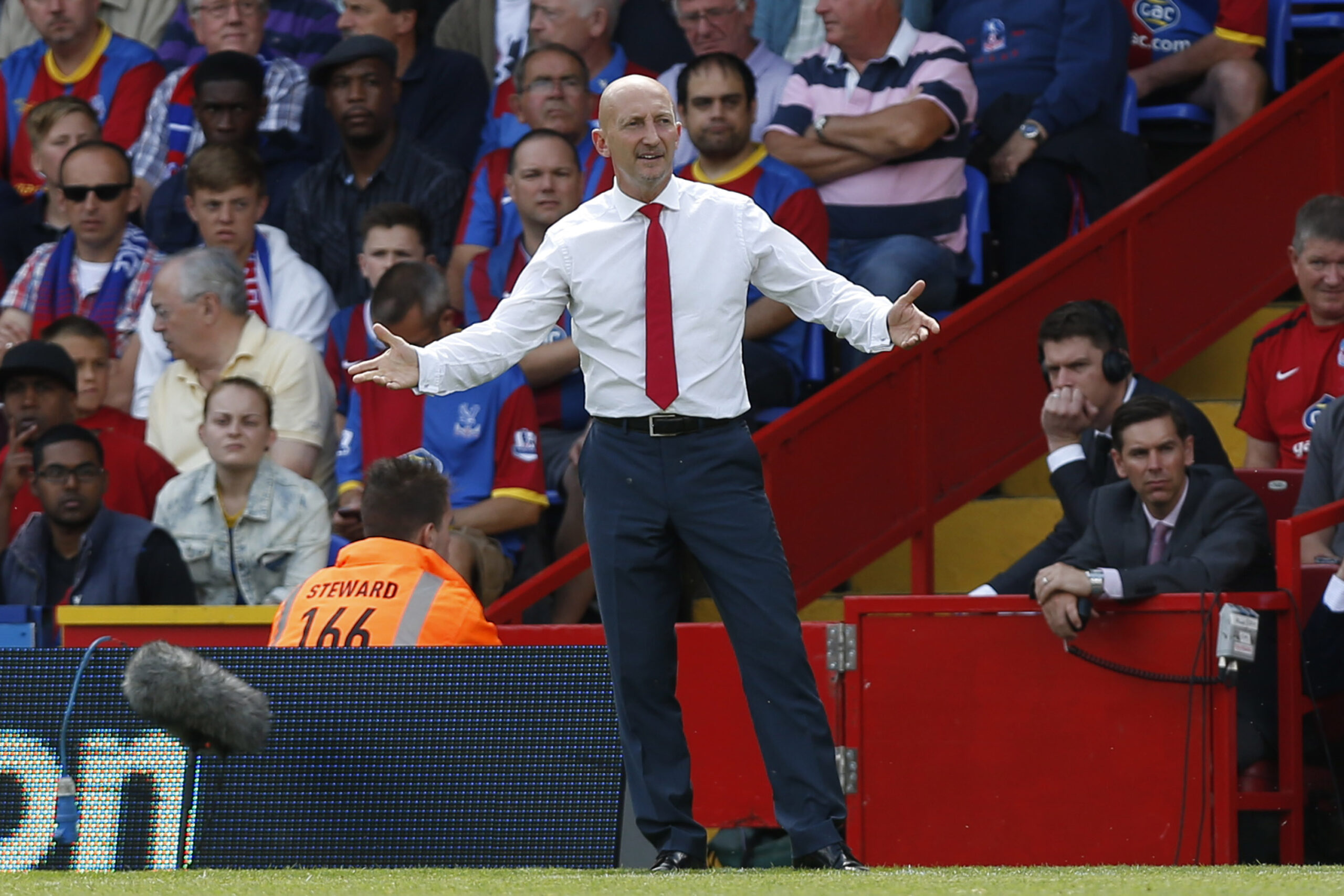 FILE - A Sunday, Aug. 18, 2013 photo from files showing Crystal Palace's manager, Ian Holloway, on the touchline as he watches his team play against Tottenham Hotspur during their English Premier League soccer match at Selhurst Park, London. Ian Holloway has left his position as Crystal Palace manager by mutual consent, with the club next to last in the Premier League after eight games. Holloways departure was confirmed at a press conference in central London on Wednesday, Oct. 23, 2013. (AP Photo/Sang Tan, File)