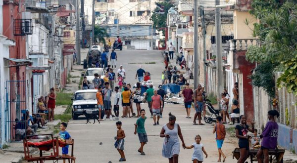 epa11673399 People walk down a street during a national blackout in Havana, Cuba, 20 October 2024 (issued 21 October 2024). Cuba's Ministry of Energy and Mines reported on 20 October a third total failure of the National Electric System (SEN) in less than three days. Cuba's state-run Union Electrica (UNE) on 21 October said that around 50 percent of Havana's residents now have power supply, after almost 72 hours of the total blackout registered on the island.  EPA/YANDER ZAMORA