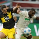 epa11684962 Ogochukwu Frank Onyeka of Augsburg (R) in action against Marcel Sabitzer of Dortmund (L) during the German Bundesliga soccer match between FC Augsburg and Borussia Dortmund in Augsburg, Germany, 26 October 2024.  EPA/RONALD WITTEK CONDITIONS - ATTENTION: The DFL regulations prohibit any use of photographs as image sequences and/or quasi-video.