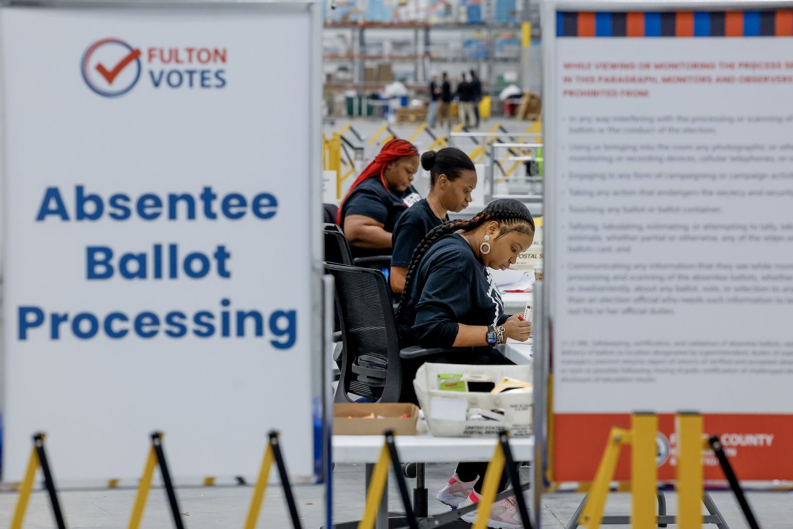 epa11701413 Workers with the Fulton County Department of Registration & Elections process absentee ballots at the county's new Elections Hub and Operations Center in Union City, Georgia, USA, 04 November 2024. Officials gave the news media a tour of the site, one day ahead of the US Election Day, 05 November 2024.  EPA/ERIK S. LESSER