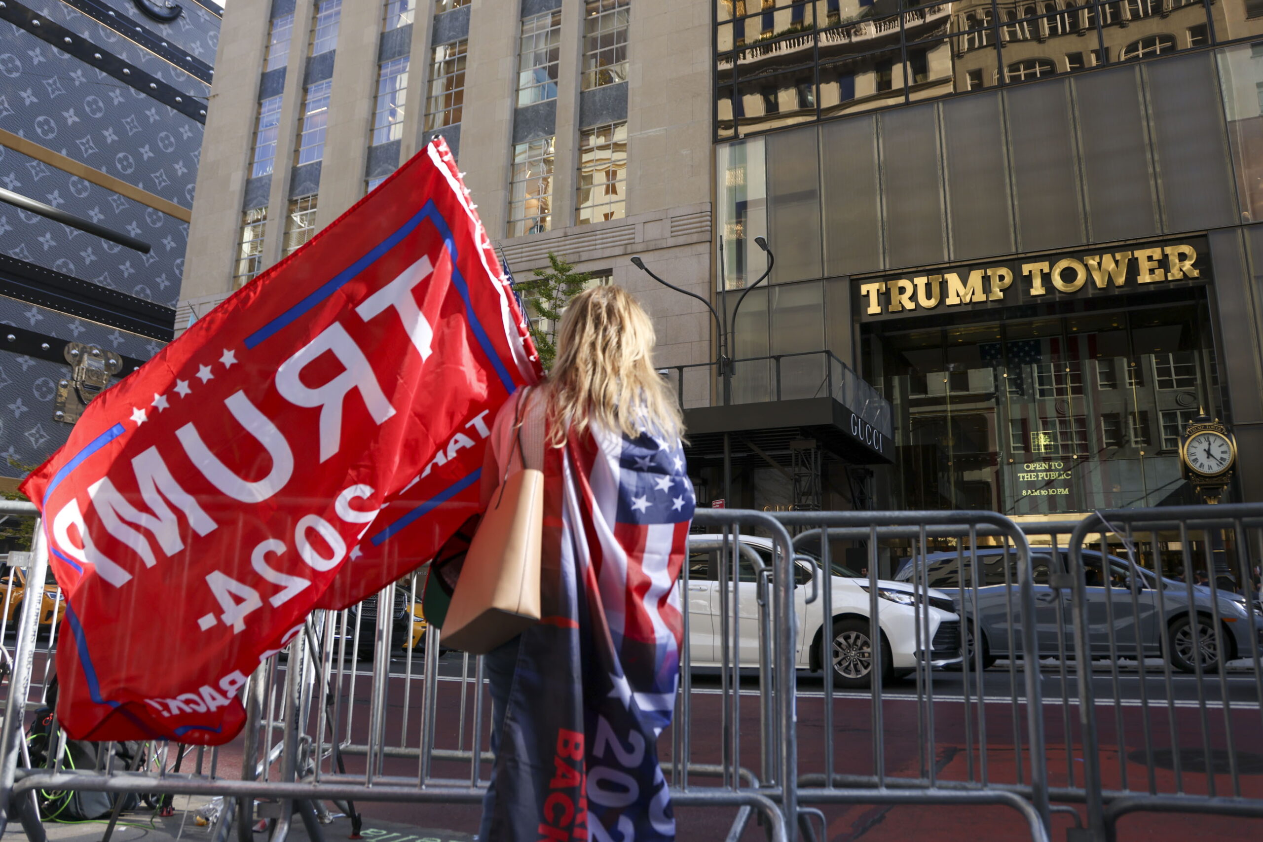 epa11705751 A person with a Donald Trump flag stands across the street from Trump Tower in New York, New York, USA, 06 November 2024. US Republican presidential candidate Donald J. Trump has been elected the 47th president of the United States after having secured more than the 270 Electoral College votes necessary, following a tightly contested race with Democratic presidential candidate US Vice President Kamala Harris.  EPA/SARAH YENESEL