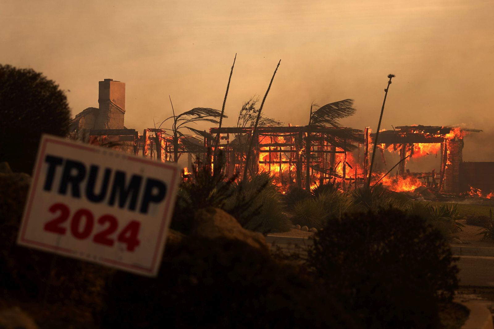 epaselect epa11706603 A home is consumed behind a Trump 2024 sign as the Mountain Fire burns in Camarillo, California, USA, 06 November 2024.  EPA/ALLISON DINNER