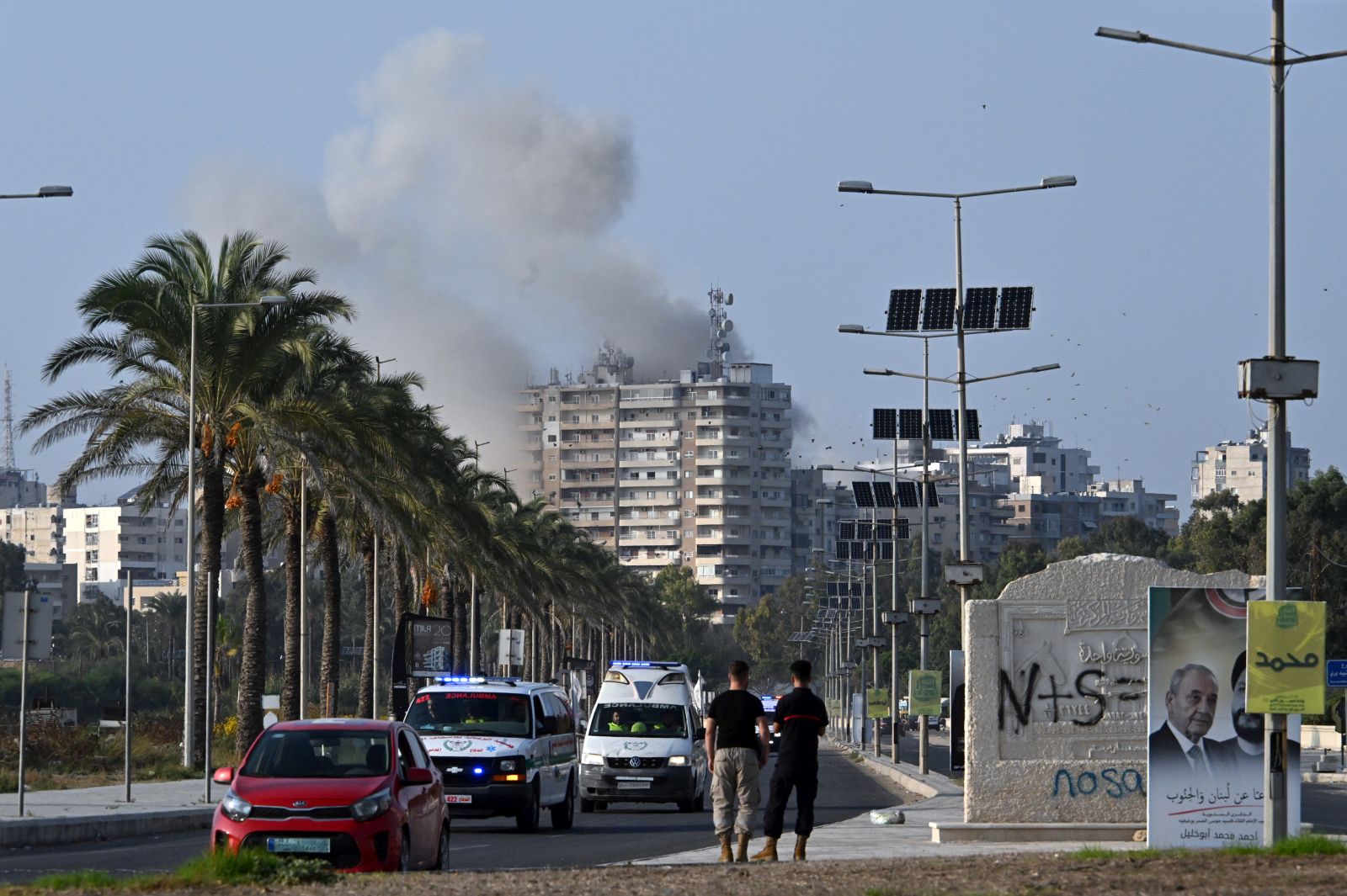 epa11707568 Smoke rises following an Israeli airstrike as ambulances transport the coffins of 16 people who were killed in an Israeli strike in the town of Barja, during the funeral in the southern port city of Tyre, Lebanon, 07 November 2024. At least 20 people were killed as a result of an Israeli airstrike on a residential building in Barja late on 05 November, the Lebanese Ministry of Health said. According to the Lebanese Ministry of Health, more than 3,000 people have been killed and over 13,600 others injured in Lebanon since the escalation in hostilities between Israel and Hezbollah.  EPA/STR