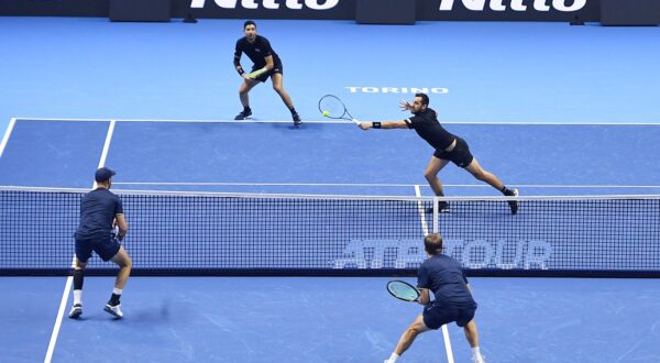 epa11714456 Kevin Krawietz of Germany and Tim Puetz of Germany in action against Marcelo Arevalo of El Salvador and Mate Pavic of Croatia during their Men's Doubles match at the Nitto ATP Finals in Turin, Italy, 11 November 2024.  EPA/ALESSANDRO DI MARCO