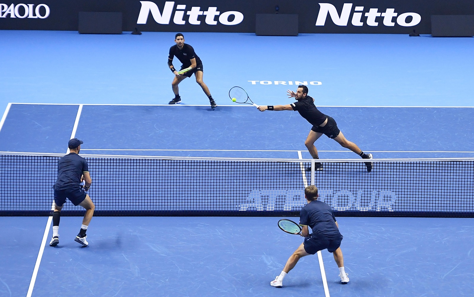 epa11714456 Kevin Krawietz of Germany and Tim Puetz of Germany in action against Marcelo Arevalo of El Salvador and Mate Pavic of Croatia during their Men's Doubles match at the Nitto ATP Finals in Turin, Italy, 11 November 2024.  EPA/ALESSANDRO DI MARCO