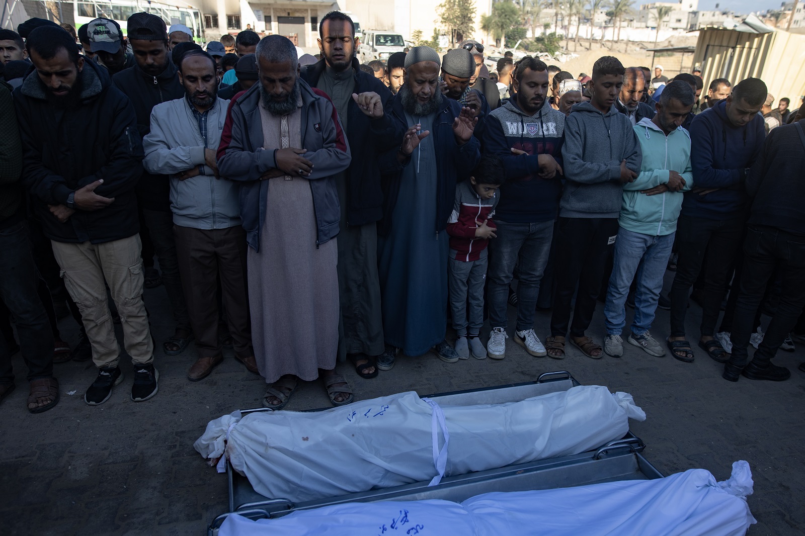 epa11715620 Palestinians pray in front of the bodies of their relatives at Nasser Hospital, in the Gaza Strip, 12 November 2024. At least 10 people were killed and several others wounded in an Israeli airstrike on a cafe west of Khan Younis, according to medics at Nasser Hospital. More than 43,600 Palestinians and over 1,400 Israelis have been killed, according to the Palestinian Health Ministry and the Israeli Army, since Hamas militants launched an attack against Israel from the Gaza Strip on 07 October 2023, and the Israeli operations in Gaza and the West Bank which followed it.  EPA/HAITHAM IMAD