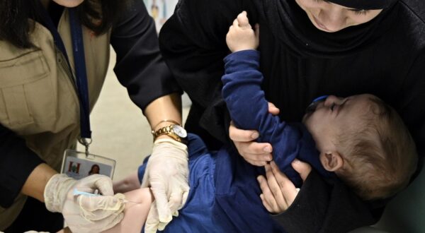 epa11720501 A parent comforts her daughter while a healthcare worker administers a measles vaccine to a child at a shelter for the displaced in the Karantina area in Beirut, Lebanon, 14 November 2024. Health workers give polio and measles vaccines to displaced children at one of the centers that houses more than 700 people who fled Israeli attacks from southern Lebanon, Beirut southern suburb and the Bekaa Valley. According to the Lebanese Ministry of Health, around 3,365 people have been killed and over 14,344 others have been injured in Lebanon since the escalation in hostilities between Israel and Hezbollah. EPA/WAEL HAMZEH  EPA-EFE/WAEL HAMZEH