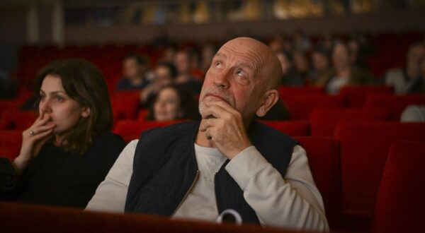 This picture taken on November 6, 2024, shows US actor John Malkovich watching the dress rehearsal for the play "Arms and the Man" which he directed at the Bulgarian National Theatre in Sofia. A 19th century play directed by US actor John Malkovich has caused a stir in Bulgaria, with critics slamming what they called the "insulting" portrayal of Bulgarians in the production. Last week's premiere of "Arms and the Man" by renowned Irish-born playwright George Bernard Shaw sparked raucous protests among nationalist groups. Holding up banners that read "Malkovich go home", angry protesters blocked access to the National theatre in the capital Sofia before attempting to storm it, accusing the 70-year-old director of ridiculing the country's history and its citizens.,Image: 933270631, License: Rights-managed, Restrictions: TO GO WITH AFP STORY BY Vessela SERGUEVA, Model Release: no, Credit line: Nikolay DOYCHINOV / AFP / Profimedia