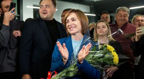 epa11699973 The incumbent President of Moldova Maia Sandu flanked by her supporters following the announcement of the preliminary election results at her campaign headquarters in Chisinau, Moldova, 03 November 2024. Moldova is holding the second round of presidential elections, with former Attorney General of Moldova Alexandr Stoianoglo facing incumbent President of Moldova Maia Sandu.  EPA/DUMITRU DORU