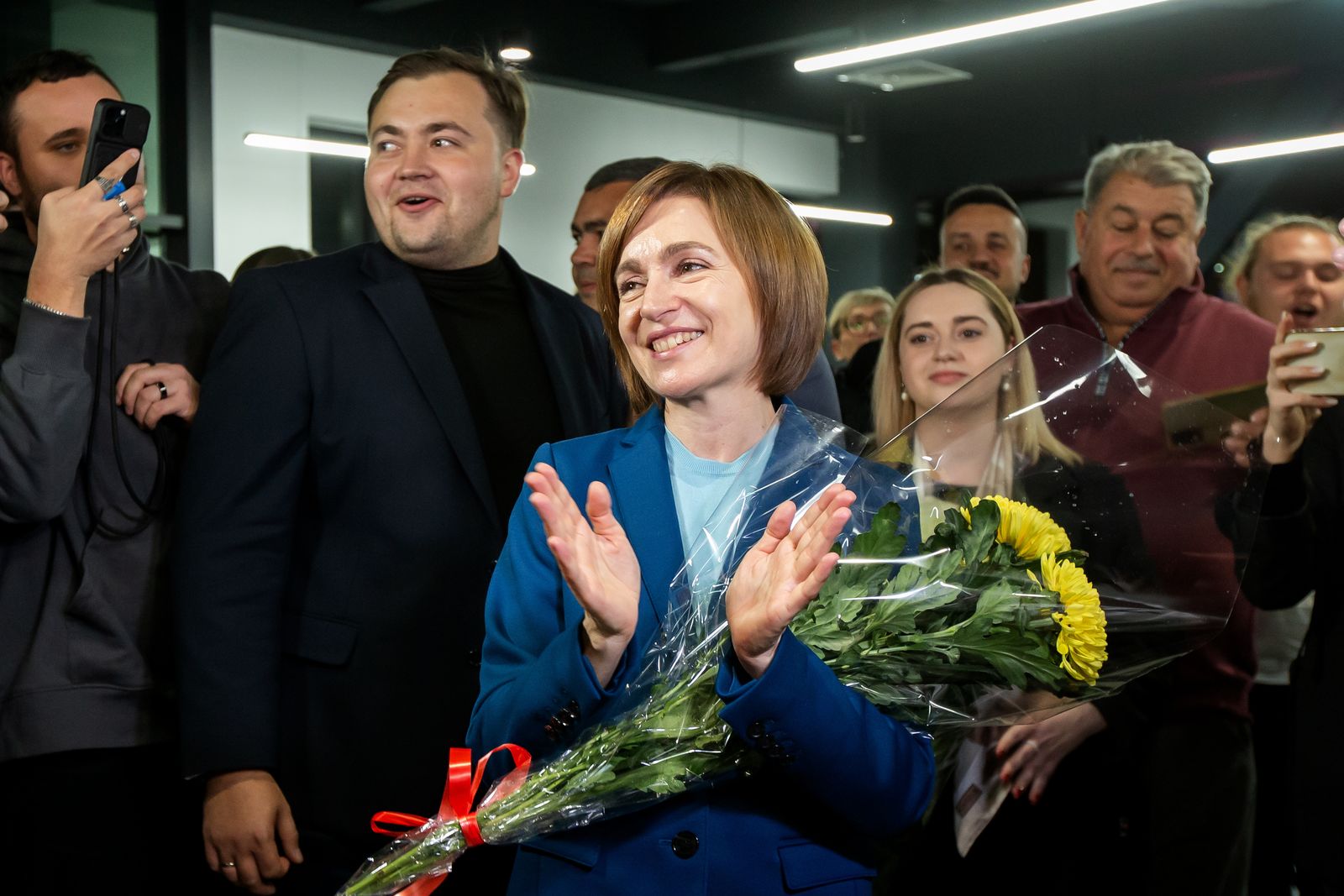 epa11699973 The incumbent President of Moldova Maia Sandu flanked by her supporters following the announcement of the preliminary election results at her campaign headquarters in Chisinau, Moldova, 03 November 2024. Moldova is holding the second round of presidential elections, with former Attorney General of Moldova Alexandr Stoianoglo facing incumbent President of Moldova Maia Sandu.  EPA/DUMITRU DORU