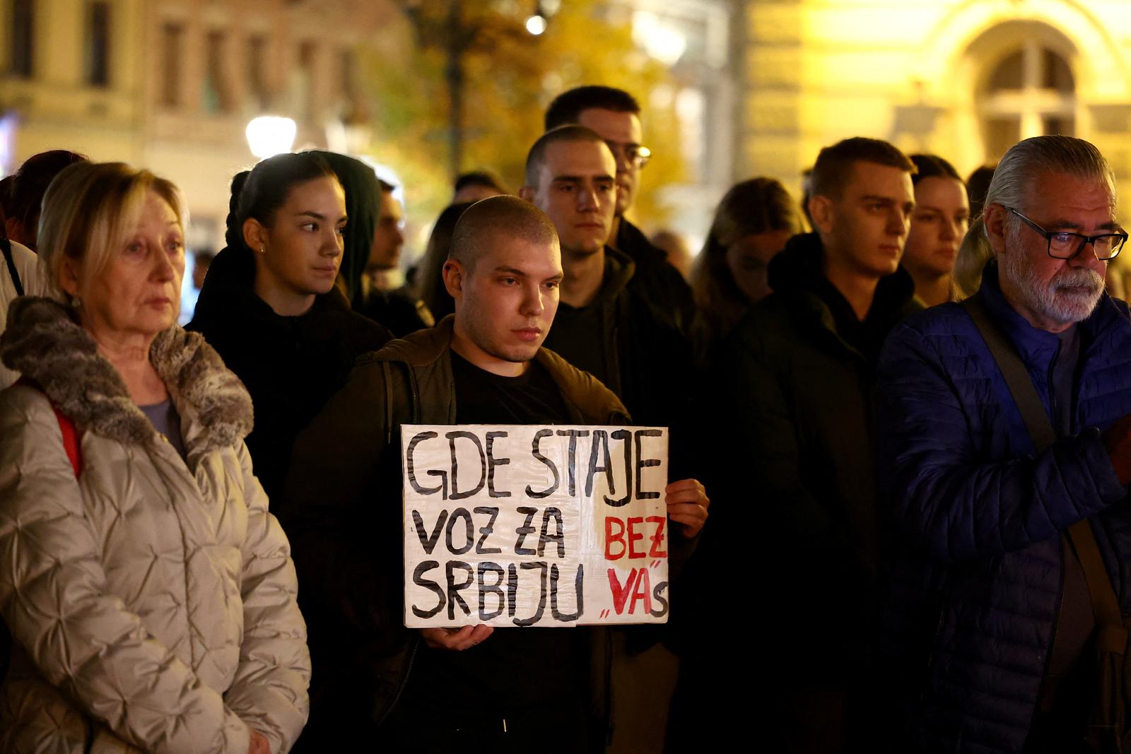 A man holds a banner that reads "Where does the train to Serbia stop without you." As people gather in front of Novi Sad city hall, following the roof of a train station collapsing, killing several people in Novi Sad, Serbia November 1, 2024. REUTERS/Zorana Jevtic Photo: ZORANA JEVTIC/REUTERS