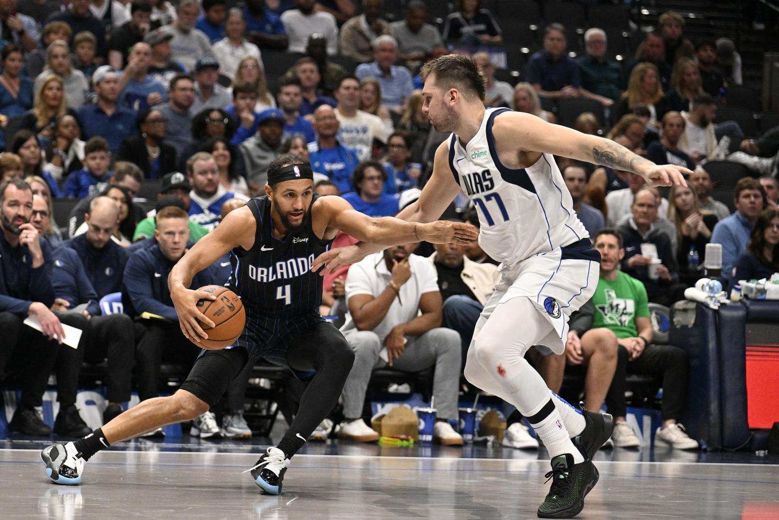 Nov 3, 2024; Dallas, Texas, USA; Orlando Magic guard Jalen Suggs (4) looks to move the ball past Dallas Mavericks guard Luka Doncic (77) during the second half at the American Airlines Center. Mandatory Credit: Jerome Miron-Imagn Images Photo: Jerome Miron/REUTERS