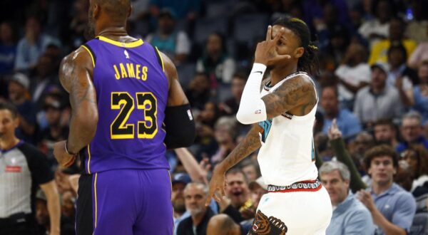 Nov 6, 2024; Memphis, Tennessee, USA; Memphis Grizzlies guard Ja Morant (12) reacts toward Los Angeles Lakers forward LeBron James (23) after a three point basket during the first half at FedExForum. Mandatory Credit: Petre Thomas-Imagn Images Photo: Petre Thomas/REUTERS