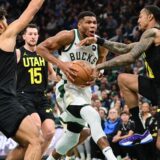 Nov 7, 2024; Milwaukee, Wisconsin, USA; Milwaukee Bucks forward Giannis Antetokounmpo (34) drives for the basket against Utah Jazz guard Johnny Juzang (33), forward Drew Eubanks (15) and center John Collins (20) in the fourth quarter at Fiserv Forum. Mandatory Credit: Benny Sieu-Imagn Images Photo: Benny Sieu/REUTERS