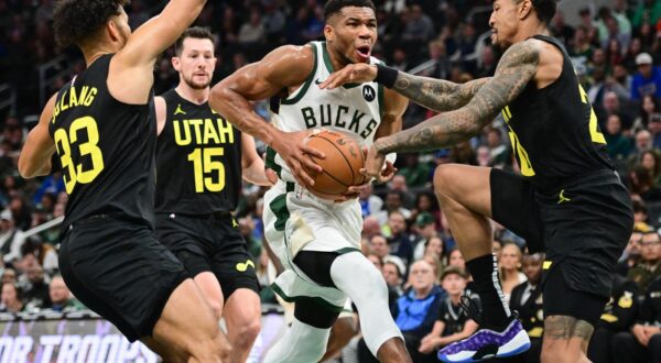 Nov 7, 2024; Milwaukee, Wisconsin, USA; Milwaukee Bucks forward Giannis Antetokounmpo (34) drives for the basket against Utah Jazz guard Johnny Juzang (33), forward Drew Eubanks (15) and center John Collins (20) in the fourth quarter at Fiserv Forum. Mandatory Credit: Benny Sieu-Imagn Images Photo: Benny Sieu/REUTERS