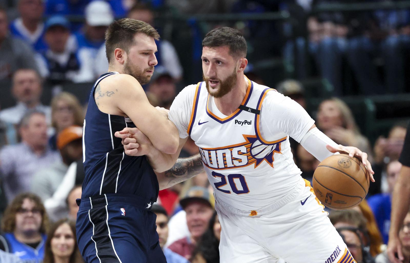 Nov 8, 2024; Dallas, Texas, USA;  Phoenix Suns center Jusuf Nurkic (20) dribbles as Dallas Mavericks guard Luka Doncic (77) defends during the first quarter at American Airlines Center. Mandatory Credit: Kevin Jairaj-Imagn Images Photo: Kevin Jairaj/REUTERS