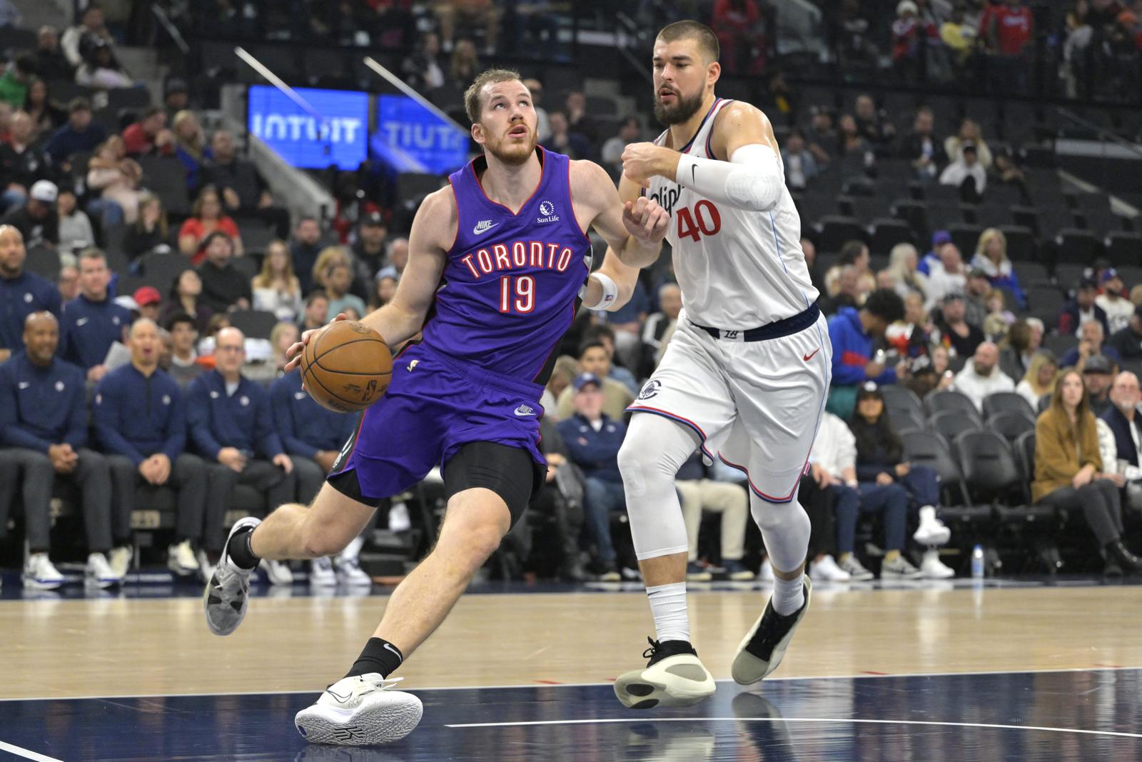 Nov 9, 2024; Inglewood, California, USA; Toronto Raptors center Jakob Poeltl (19) is defended by Los Angeles Clippers center Ivica Zubac (40) as he drives to the basket in the first half at Intuit Dome. Mandatory Credit: Jayne Kamin-Oncea-Imagn Images Photo: Jayne Kamin-Oncea/REUTERS