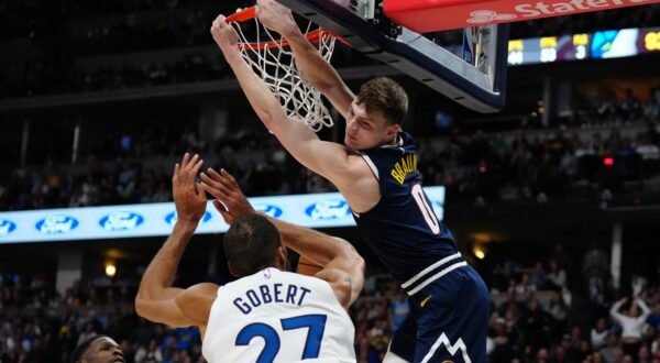 Apr 10, 2024; Denver, Colorado, USA; Denver Nuggets guard Christian Braun (0) finishes off a dunk over Minnesota Timberwolves center Rudy Gobert (27) and guard Anthony Edwards (5)  in the second half at Ball Arena. Mandatory Credit: Ron Chenoy-USA TODAY Sports Photo: Ron Chenoy/REUTERS