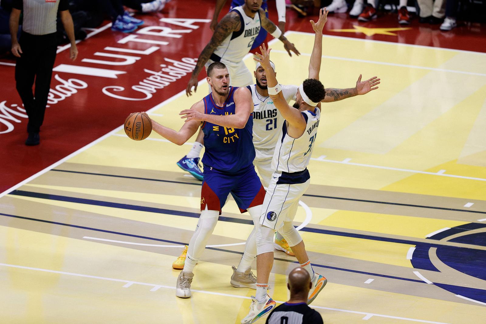 Nov 22, 2024; Denver, Colorado, USA; Denver Nuggets center Nikola Jokic (15) controls the ball under pressure from Dallas Mavericks center Daniel Gafford (21) and guard Klay Thompson (31) in the second quarter at Ball Arena. Mandatory Credit: Isaiah J. Downing-Imagn Images Photo: Isaiah J. Downing/REUTERS