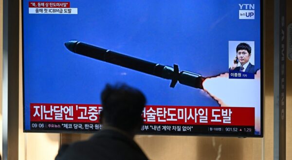 A man watches a television screen showing a news broadcast with file footage of a North Korean missile test, at a train station in Seoul on October 31, 2024. North Korea on October 31 fired a 