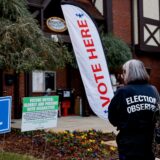 epa11702601 An election observer with the American Civil Liberties Union (ACLU) monitors activity as voters arrive to cast their ballots at the Dekalb County Avondale Estates City Hall voting precinct as the polls open on Election Day in Avondale Estates, Georgia, USA, 05 November 2024. Voters across the country are casting ballots today for President of the United States in a tightly contested race between Republican presidential candidate Donald J. Trump and Democratic presidential candidate US Vice President Kamala Harris, as well as for candidates in Senate and Congressional races.  EPA/ERIK S. LESSER