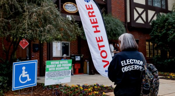 epa11702601 An election observer with the American Civil Liberties Union (ACLU) monitors activity as voters arrive to cast their ballots at the Dekalb County Avondale Estates City Hall voting precinct as the polls open on Election Day in Avondale Estates, Georgia, USA, 05 November 2024. Voters across the country are casting ballots today for President of the United States in a tightly contested race between Republican presidential candidate Donald J. Trump and Democratic presidential candidate US Vice President Kamala Harris, as well as for candidates in Senate and Congressional races.  EPA/ERIK S. LESSER