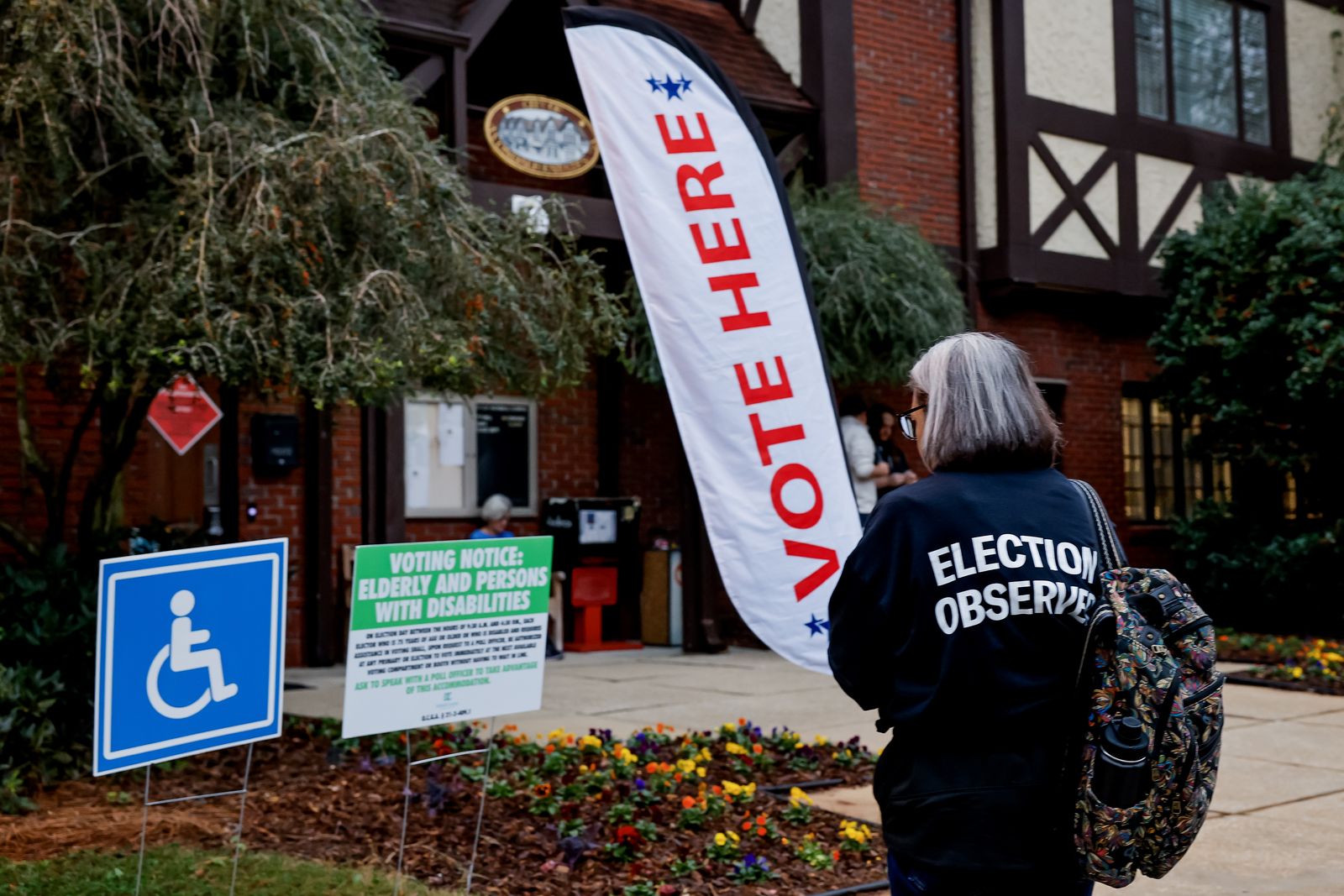 epa11702601 An election observer with the American Civil Liberties Union (ACLU) monitors activity as voters arrive to cast their ballots at the Dekalb County Avondale Estates City Hall voting precinct as the polls open on Election Day in Avondale Estates, Georgia, USA, 05 November 2024. Voters across the country are casting ballots today for President of the United States in a tightly contested race between Republican presidential candidate Donald J. Trump and Democratic presidential candidate US Vice President Kamala Harris, as well as for candidates in Senate and Congressional races.  EPA/ERIK S. LESSER