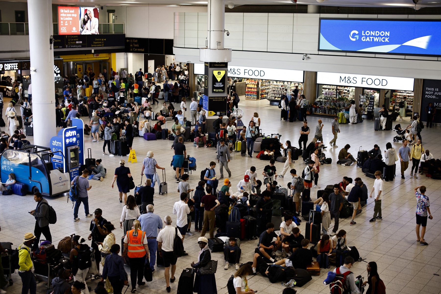 Passengers wait in the south terminal of Gatwick Airport as some flights are cancelled or delayed, in Horley, south of London on July 19, 2024. The British government said Friday that it had activated its civil contingencies committee to handle the response to a global IT outage that hit UK transport and health services. Airports including London Luton, Belfast and Edinburgh warned of longer waiting times for passengers because of the glitch, which was apparently caused by an update to an antivirus programme.,Image: 890832537, License: Rights-managed, Restrictions: , Model Release: no, Credit line: BENJAMIN CREMEL / AFP / Profimedia