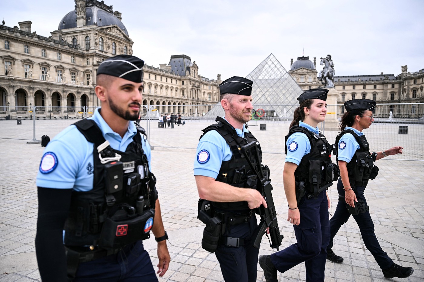 French gendarmes patrol in front of the Pyramide du Louvre, designed by Chinese-US architect Ieoh Ming Pei, a few hours prior to the start of the opening ceremony of the Paris 2024 Olympic Games in Paris on July 26, 2024.,Image: 892628730, License: Rights-managed, Restrictions: , Model Release: no, Credit line: Kirill KUDRYAVTSEV / AFP / Profimedia