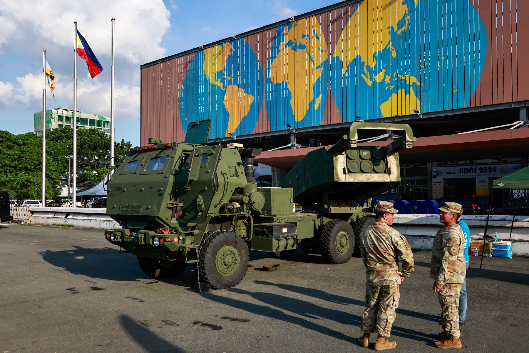 PASAY, METRO MANILA, PHILIPPINES - SEPTEMBER 25: Two American soldiers are seen in front of a M142 High Mobility Artillery Rocket System (HIMARS) vehicle parked outside the World Trade Center during the 2024 Asian Defense and Security Exhibition (ADAS), in Pasay City, Metro Manila, the Philippines, on 25 September, 2024. The ADAS exhibition features weapons, military equipment and vehicles from companies from various countries including Turkiye, United States, Germany, France; India, South Korea and China, with two days of symposiums to discuss issues on South China Sea or West Philippines Sea tensions, and how QUAD member states such as Japan, United States and Australia as well as European countries can collaborate in the Asia Pacific region. Daniel Ceng / Anadolu/ABACAPRESS.COM,Image: 911700598, License: Rights-managed, Restrictions: , Model Release: no, Credit line: AA/ABACA / Abaca Press / Profimedia