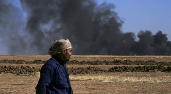 A man looks on as thick smoke rises from an oil extracting facility targeted by Turkish shelling near Syria's northeastern border with Turkey in the Qahtaniyah countryside in the far northeast corner of Hasakeh province on October 25, 2024. A Syria war monitor said on October 25 that Turkish drone strikes had killed 27 civilians in Syria in a 24-hour military escalation, following a deadly attack on a defence company near Ankara.,Image: 926194377, License: Rights-managed, Restrictions: , Model Release: no, Credit line: Delil SOULEIMAN / AFP / Profimedia