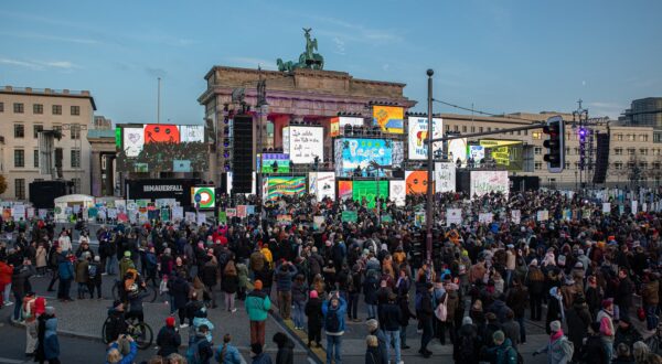 November 9, 2024, Berlin, Germany: Today, on November 9, 2024, Berlin commemorates the 35th anniversary of the Berlin Wall's fall, a milestone that ended Germany's division and marked the peaceful end of East Germany's communist regime. The fall of the Wall on November 9, 1989, symbolized freedom and inspired global movements toward democracy, driven by the courageous actions of East Germans who defied the oppressive Socialist Unity Party (SED) dictatorship. Thousands gathered across iconic Berlin sites, Checkpoint Charlie, Brandenburg Gate, the Reichstag, Potsdamer Platz, and Marshallbruecke, to honor the memory of this historic revolution and reflect on its continued significance. In 1989, mass protests across East Germany demanded basic freedoms like the right to travel, freedom of speech, and freedom of assembly. The spirit of resistance in Leipzig, Berlin, and other cities was fueled by changes in Eastern Europe, including Poland's SolidarnoÅ›Ä‡ movement and Hungary's shift toward democracy, which provided both inspiration and momentum for East German citizens. Banners during that time read ''Democracy â€“ Now or Never,'' ''Free Press for Free People,'' and ''Freedom is Indivisible.'' The slogans, resonant then, echo still in today's world, where democratic values face mounting challenges. This year's theme, ''Hold Freedom High!'' reflects a renewed call for vigilance and unity in defending those hard-won freedoms. The day's events include an extensive open-air installation marking the former path of the Wall, showcasing replicas of banners from the 1989 protests alongside new creations made in workshops by Berliners of all ages. The installation stretches from Invalidenstrasse through Checkpoint Charlie to Axel-Springer-Strasse, symbolically merging historical demands for freedom with the hopes and challenges of today. Attendees are invited to reflect on the sacrifices of those who lo,Image: 932493688, License: Rights-managed, Restrictions: , Model Release: no, Credit line: Michael Kuenne / Zuma Press / Profimedia