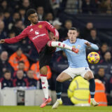 Manchester, England, 15th December 2024. Amad Diallo of Manchester United, ManU tackled by Phil Foden of Manchester City during the Premier League match at the Etihad Stadium, Manchester. Picture credit should read: Andrew Yates / Sportimage EDITORIAL USE ONLY. No use with unauthorised audio, video, data, fixture lists, club/league logos or live services. Online in-match use limited to 120 images, no video emulation. No use in betting, games or single club/league/player publications. SPI-3541-0022