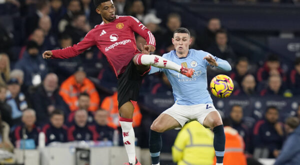 Manchester, England, 15th December 2024. Amad Diallo of Manchester United, ManU tackled by Phil Foden of Manchester City during the Premier League match at the Etihad Stadium, Manchester. Picture credit should read: Andrew Yates / Sportimage EDITORIAL USE ONLY. No use with unauthorised audio, video, data, fixture lists, club/league logos or live services. Online in-match use limited to 120 images, no video emulation. No use in betting, games or single club/league/player publications. SPI-3541-0022