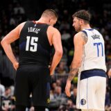 Dallas Mavericks guard Luka Doncic (77) and Denver Nuggets center Nikola Jokic (15) talk during the second quarter of an NBA basketball game Monday, Dec. 18, 2023, in Denver. (AP Photo/Jack Dempsey) Mavericks Nuggets Basketball