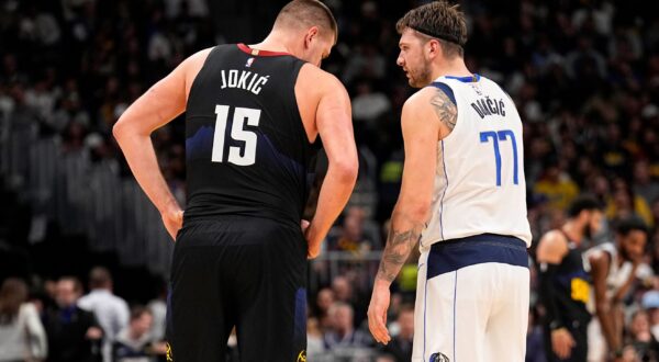 Dallas Mavericks guard Luka Doncic (77) and Denver Nuggets center Nikola Jokic (15) talk during the second quarter of an NBA basketball game Monday, Dec. 18, 2023, in Denver. (AP Photo/Jack Dempsey) Mavericks Nuggets Basketball