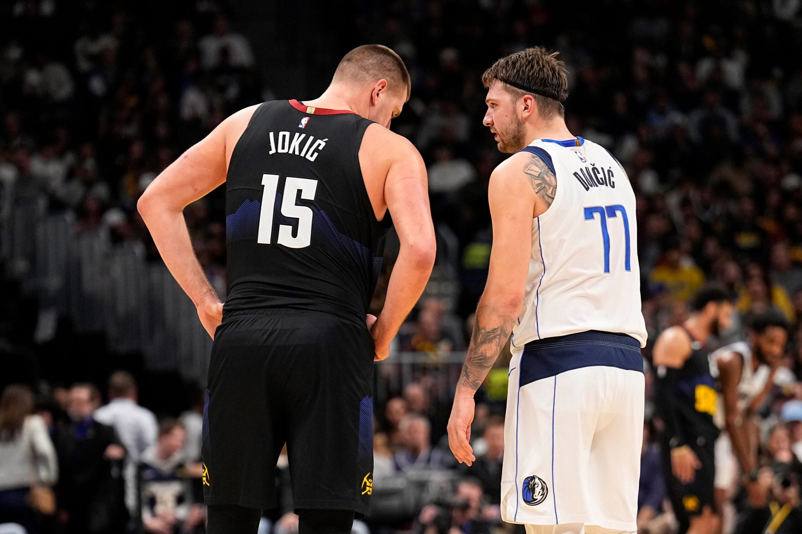 Dallas Mavericks guard Luka Doncic (77) and Denver Nuggets center Nikola Jokic (15) talk during the second quarter of an NBA basketball game Monday, Dec. 18, 2023, in Denver. (AP Photo/Jack Dempsey) Mavericks Nuggets Basketball