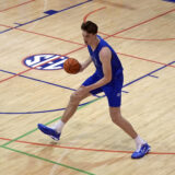 Olivier Rioux, 7-foot-9 NCAA college basketball player at Florida, moves the ball downcourt at the team's practice, Friday, Oct. 18, 2024, in Gainesville, Fla. (AP Photo/John Raoux)