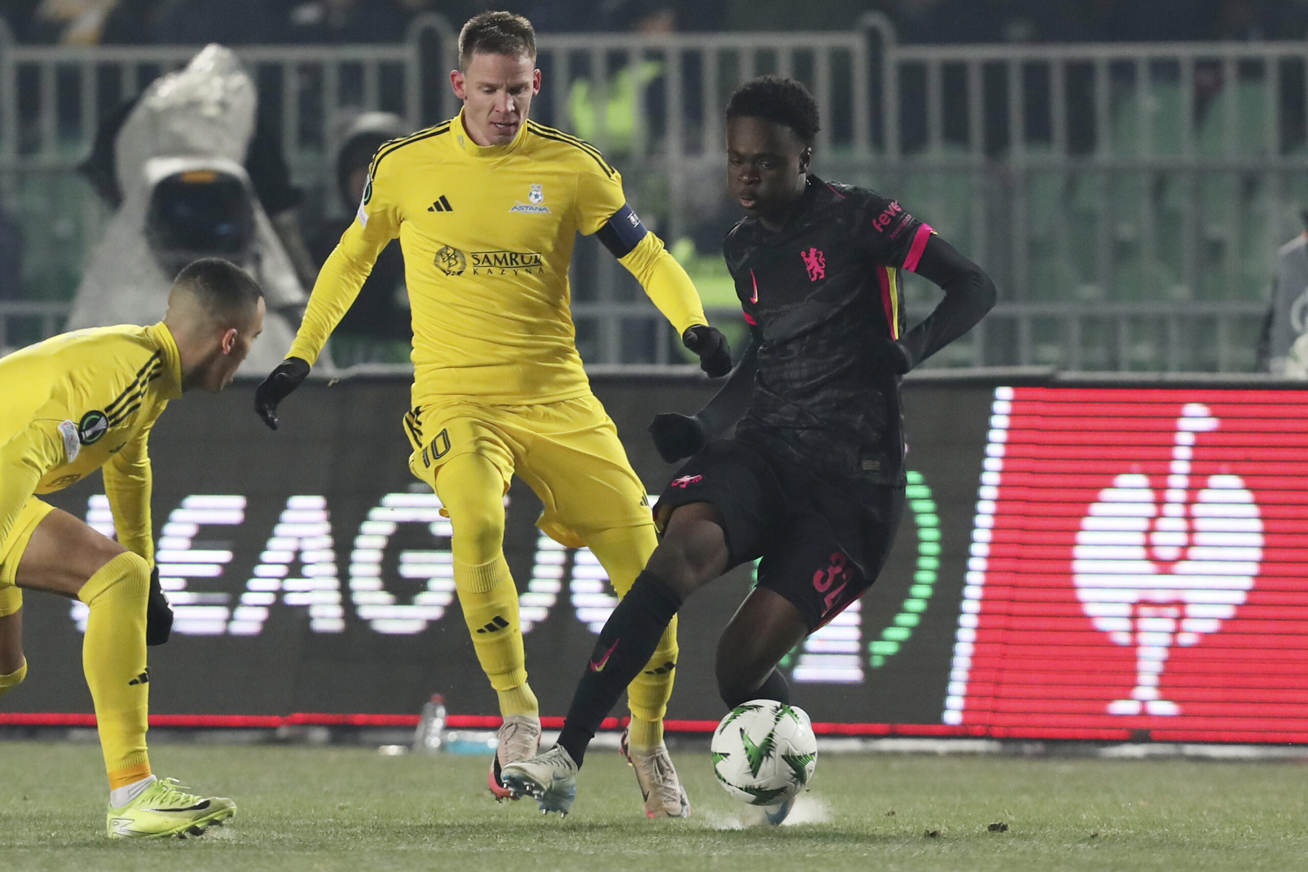 Chelsea's Tyrique George, right, fights for the ball with Astana's Marin Tomasov during the Europa Conference League opening phase soccer match between Astana and Chelsea at the Almaty Ortalyk stadium in Almaty, Kazakhstan, Thursday, Dec. 12, 2024. (AP Photo)