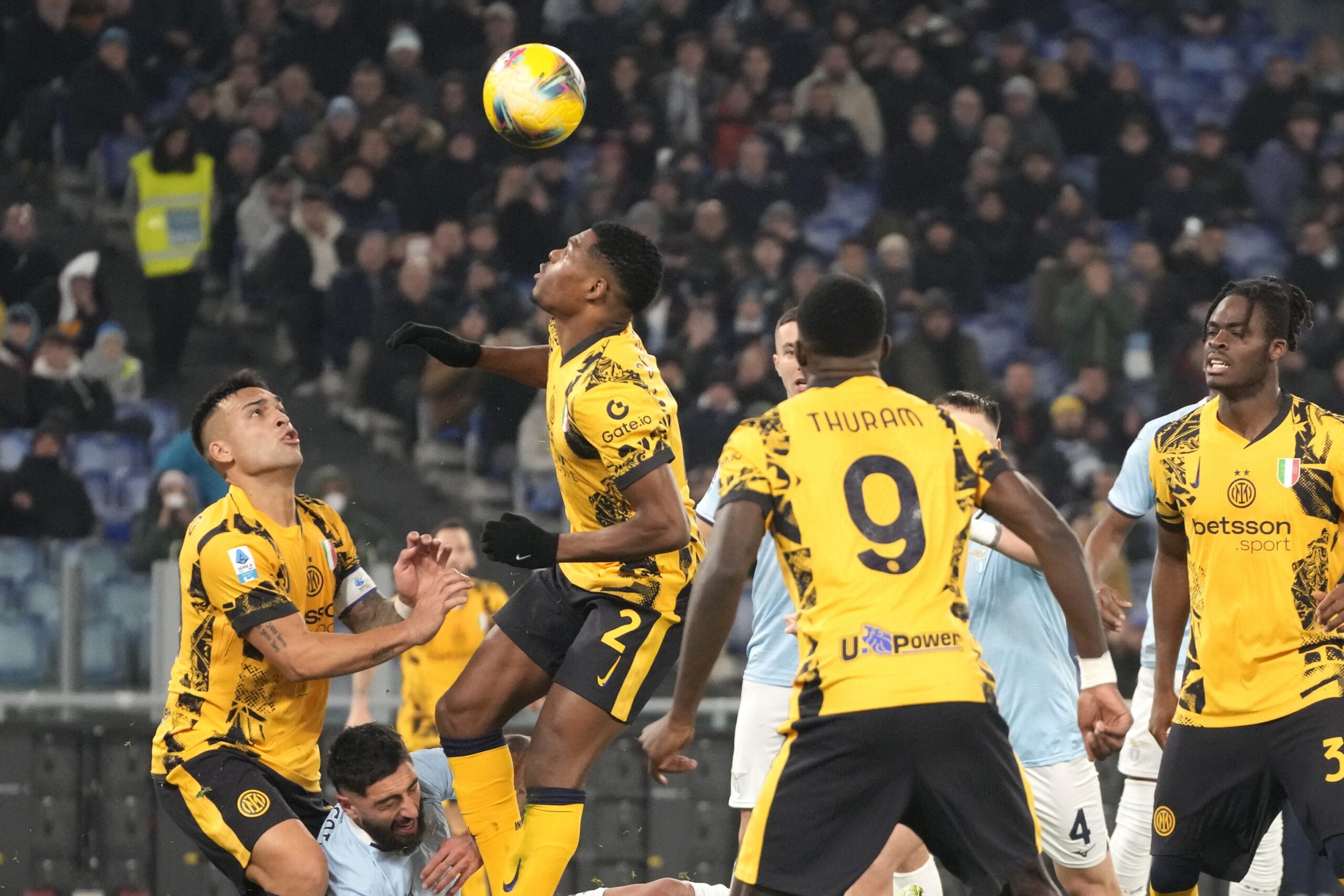 Inter Milan's Denzel Dumfries, centre, controls the ball during the Italian Serie A soccer match between Lazio and Inter at Rome's Olympic Stadium, Rome, Italy, Monday, Dec. 16, 2024. (AP Photo/Gregorio Borgia)