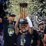 Milwaukee Bucks forward Giannis Antetokounmpo (34) yells while lifting up the NBA Cup after his team's victory in the championship game of the NBA Cup basketball tournament against the Oklahoma City Thunder Tuesday, Dec. 17, 2024, in Las Vegas. (AP Photo/Ian Maule) NBA Cup Bucks Thunder Basketball