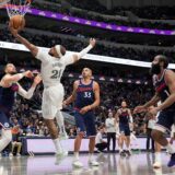 Dallas Mavericks center Daniel Gafford (21) grabs a rebound in front of Los Angeles Clippers' Ivica Zubac, left, Nicolas Batum (33) and James Harden (1) in the second half of an NBA basketball game in Dallas, Thursday, Dec. 19, 2024. (AP Photo/Tony Gutierrez) Clippers Mavericks Basketball