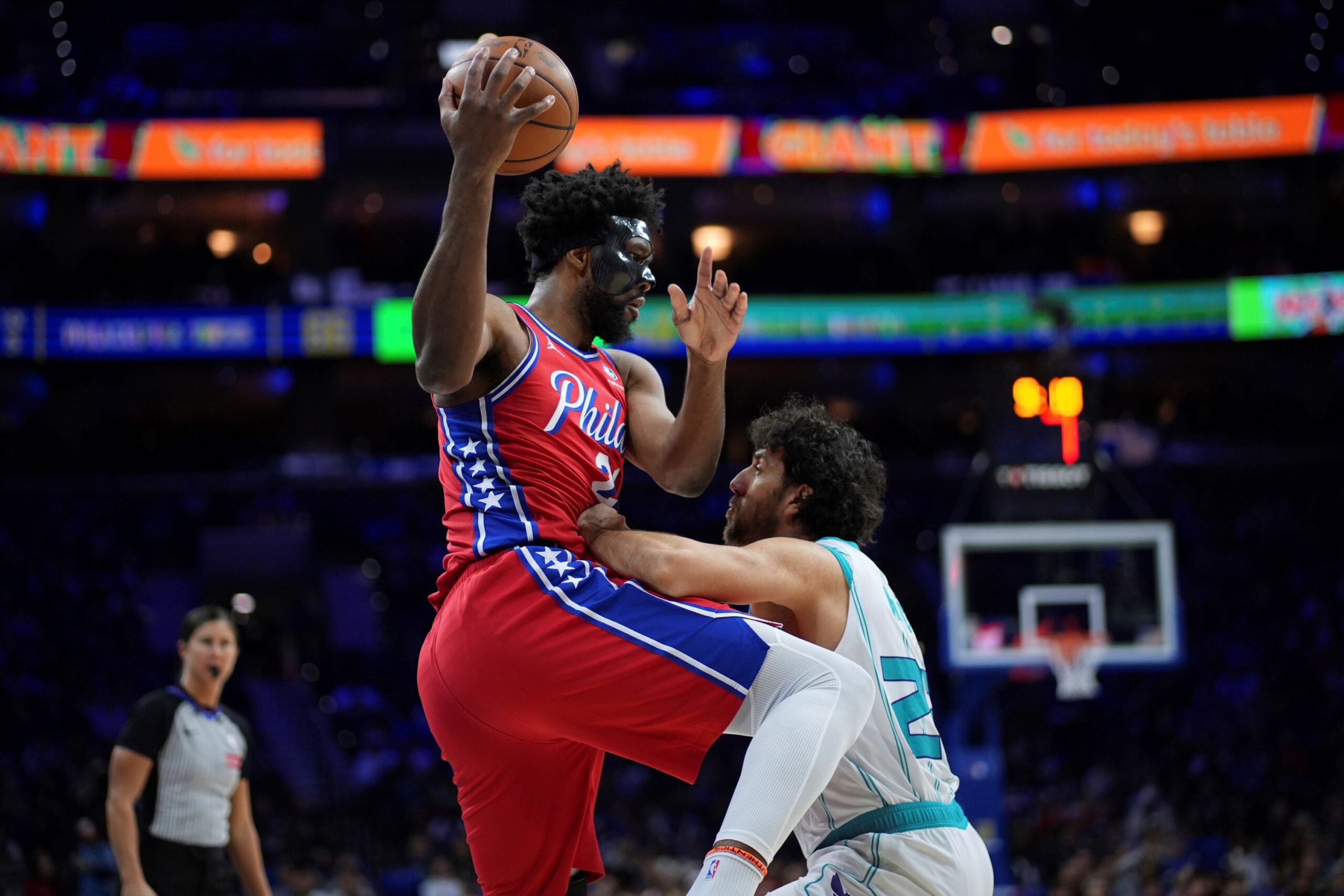 Philadelphia 76ers' Joel Embiid left, tries to go up for a shot against Charlotte Hornets' Vasilije Micic during the second half of an NBA basketball game, Friday, Dec. 20, 2024, in Philadelphia. (AP Photo/Matt Slocum) Hornets 76ers Basketball