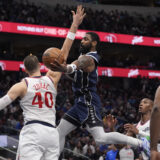 Dallas Mavericks guard Kyrie Irving (11) drives against Los Angeles Clippers center Ivica Zubac (40) during the second half of an NBA basketball game Saturday, Dec. 21, 2024, in Dallas. (AP Photo/LM Otero)