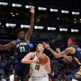 Denver Nuggets center Nikola Jokic (15) goes to the basket between New Orleans Pelicans center Yves Missi (21) and guard Brandon Boston (11) in the second half of an NBA basketball game in New Orleans, Sunday, Dec. 22, 2024. The Nuggets won in overtime 132-129. (AP Photo/Gerald Herbert) Nuggets Pelicans Basketball