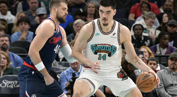 Memphis Grizzlies center Zach Edey (14) handles the ball against Los Angeles Clippers center Ivica Zubac (40) in the first half of an NBA basketball game Monday, Dec. 23, 2024, in Memphis, Tenn. (AP Photo/Brandon Dill)